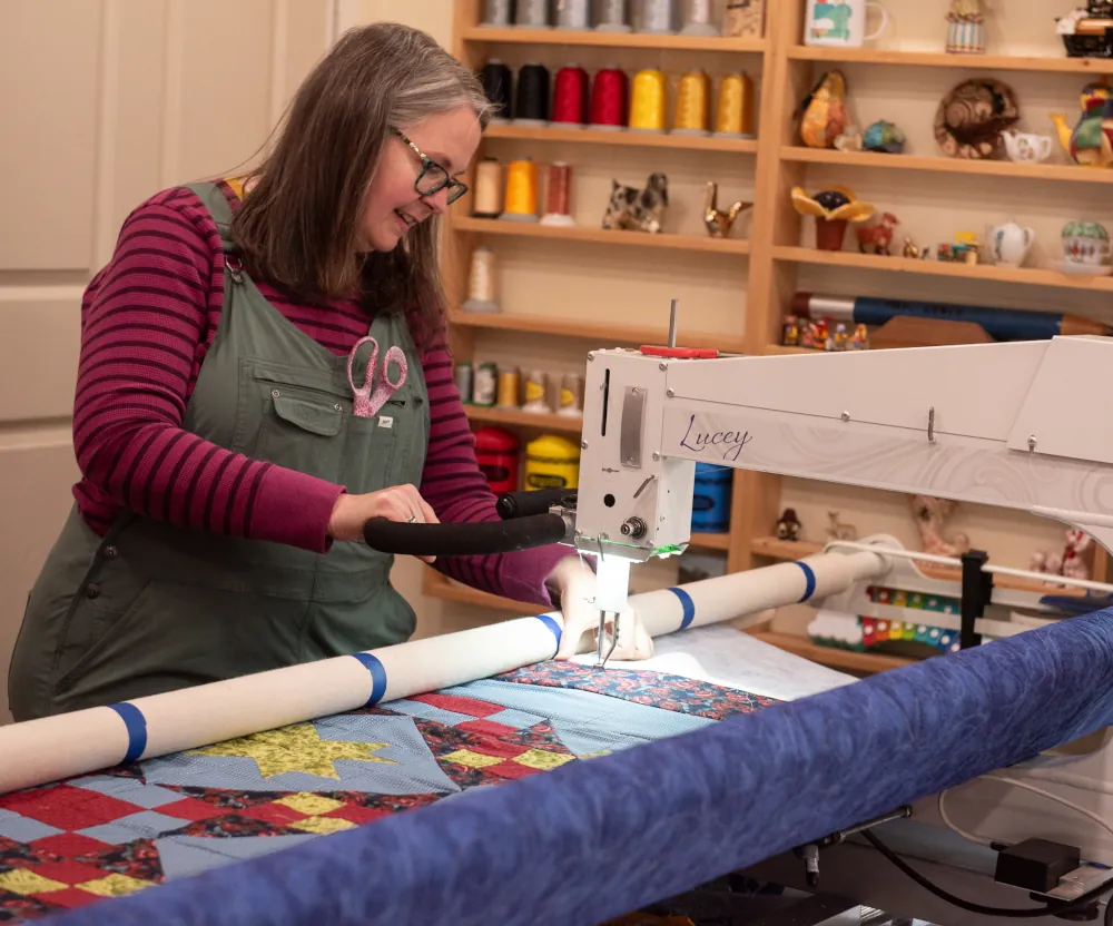 Amy using the the long arm sewing machine named Lucy