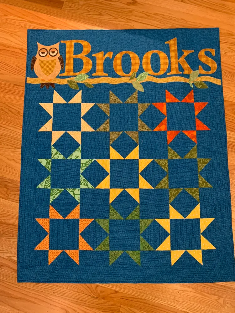 a baby quilt with the name Brooks