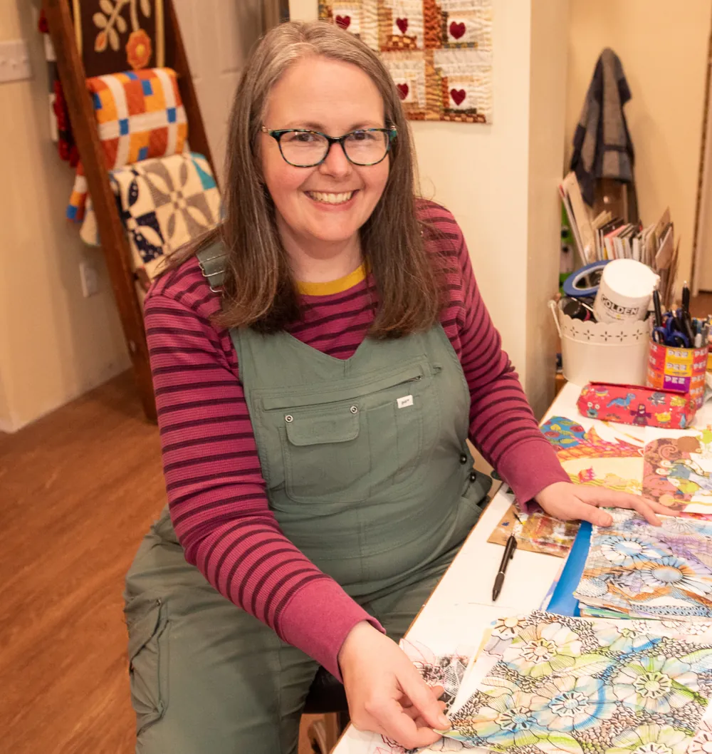 founder of blue goose at a desk with kids artwork